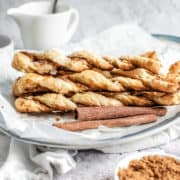 Puff pastry cinnamon twists on a plate.