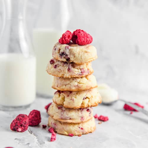 Raspberry cheesecake cookies in a stack on a table.