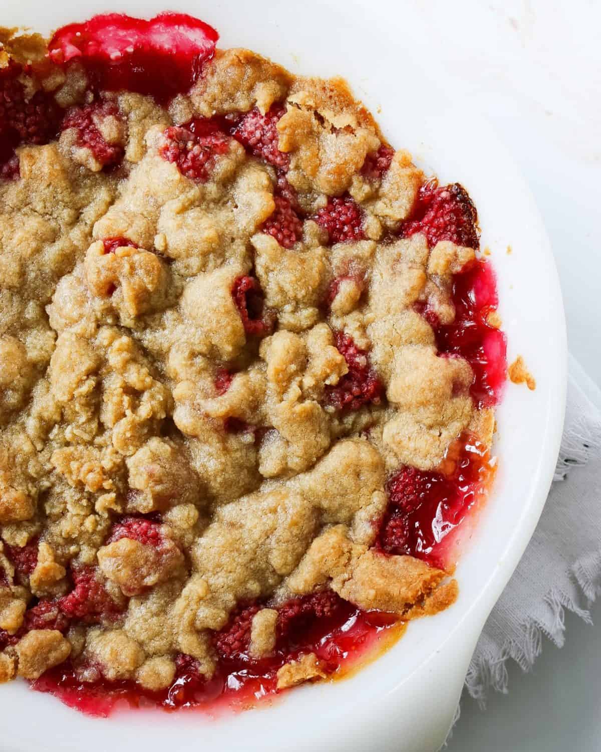 A bowl of raspberry crisp up close from above.