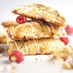 Three raspberry white chocolate scones in a stack.