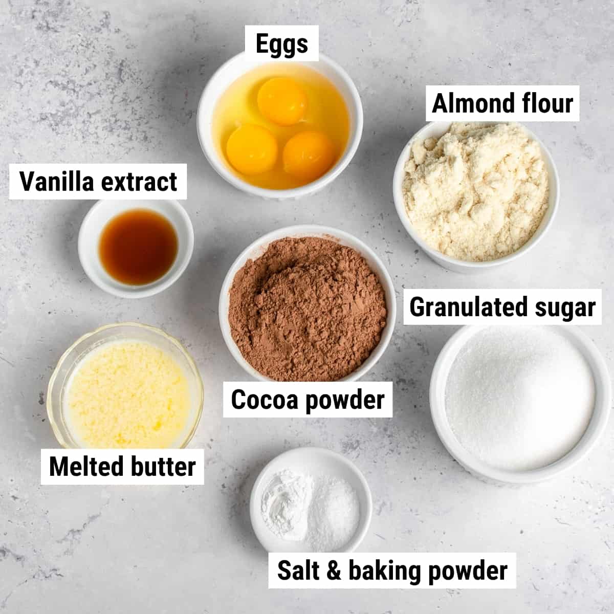 The ingredients used to make almond flour brownies laid out on a table.