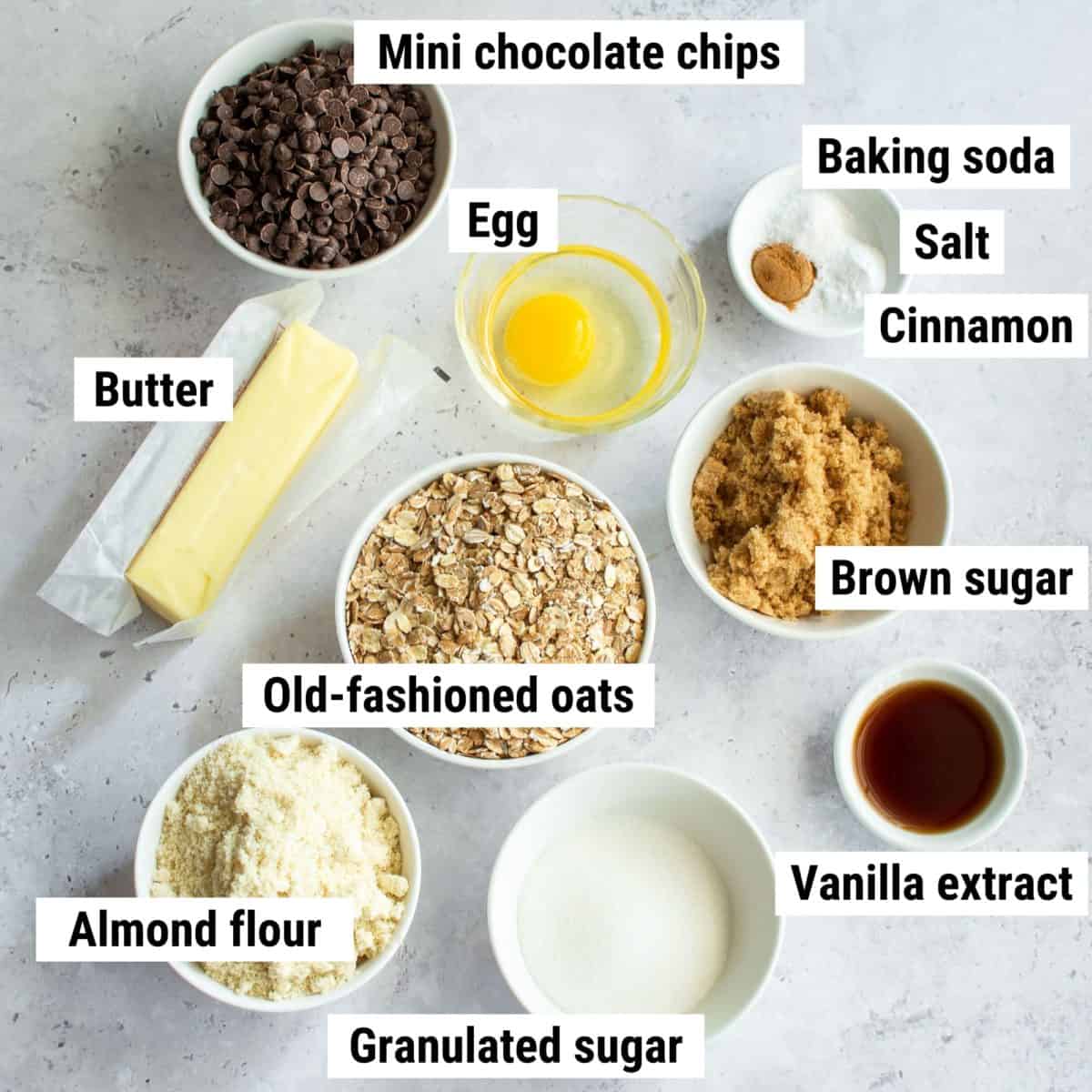The ingredients used to make almond flour oatmeal cookies spread out on a table.
