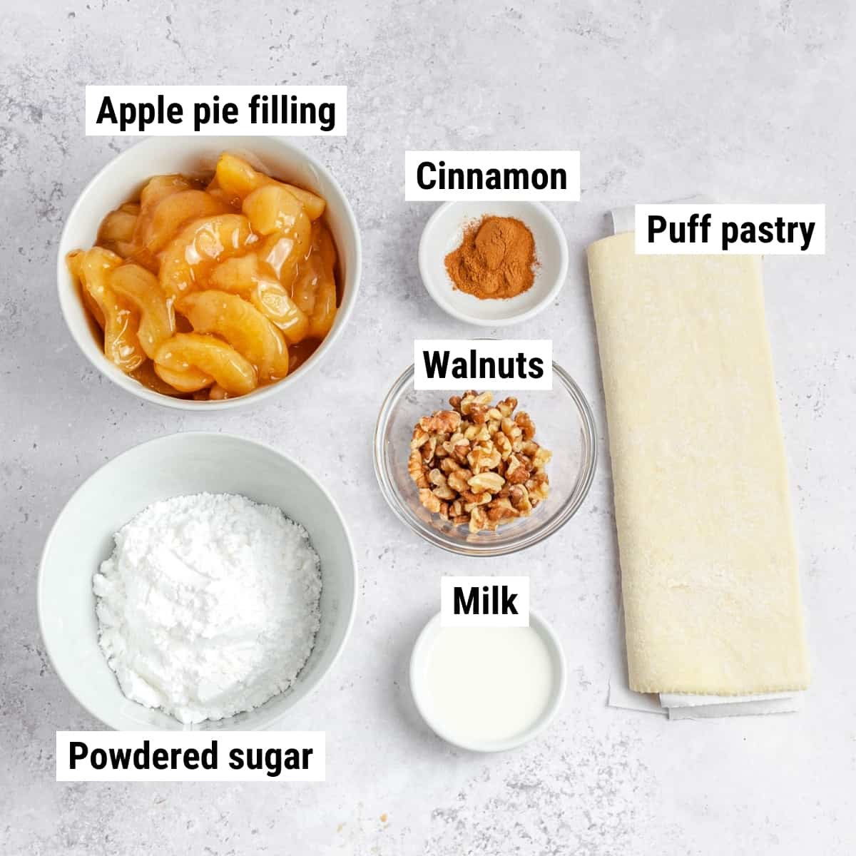 The ingredients used to make apply pie puff pastry spread out on a table.