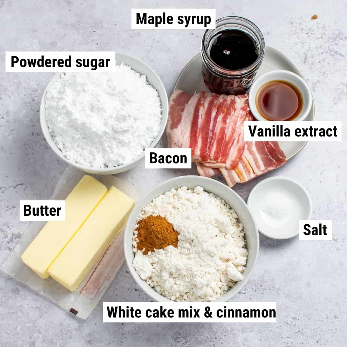 The ingredients used to make bacon maple cupcakes spread out on a table.