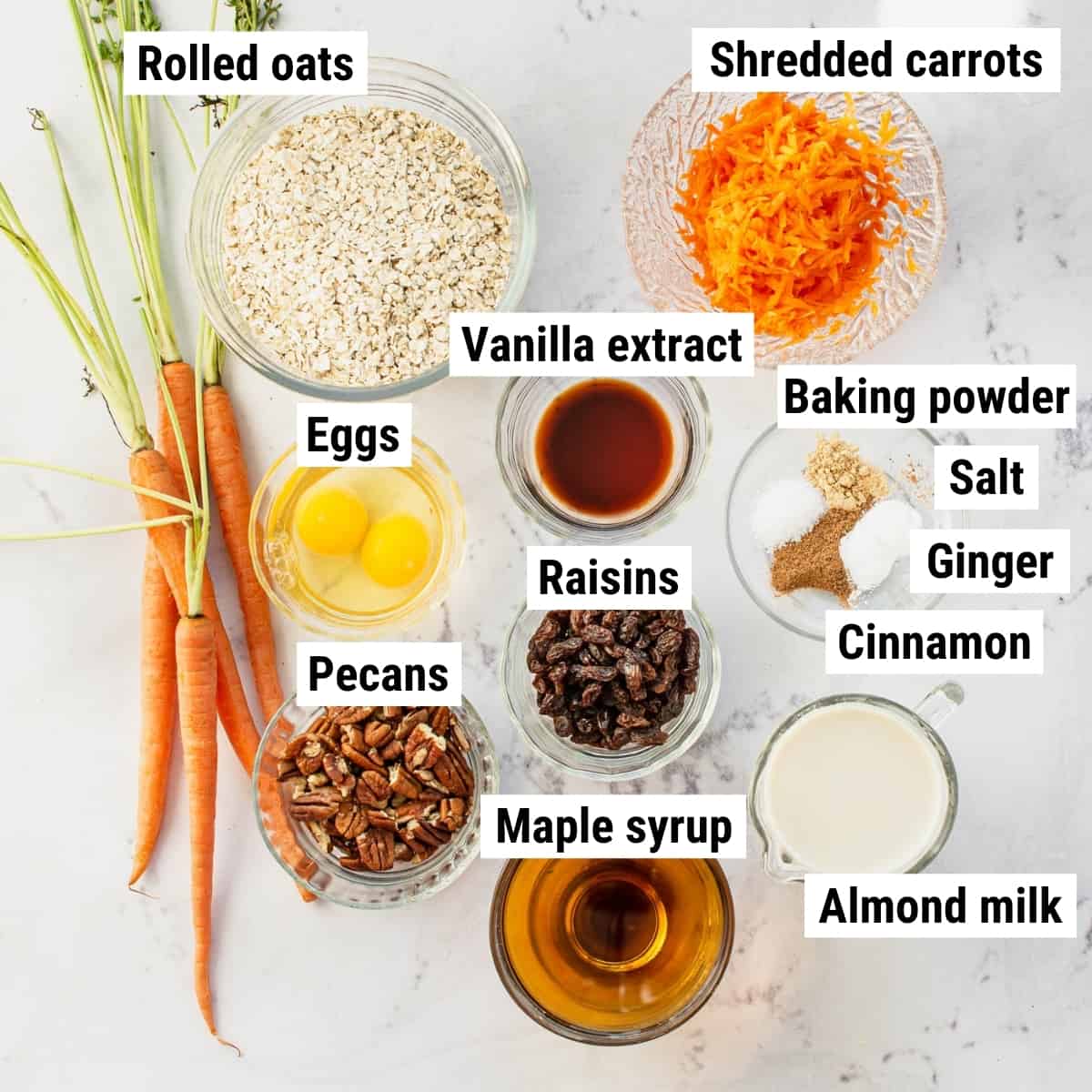 The ingredients to make carrot cake oatmeal spread out on a table.