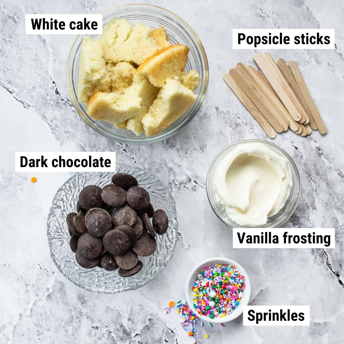 The ingredients used to make cake popsicles laid out on a table.