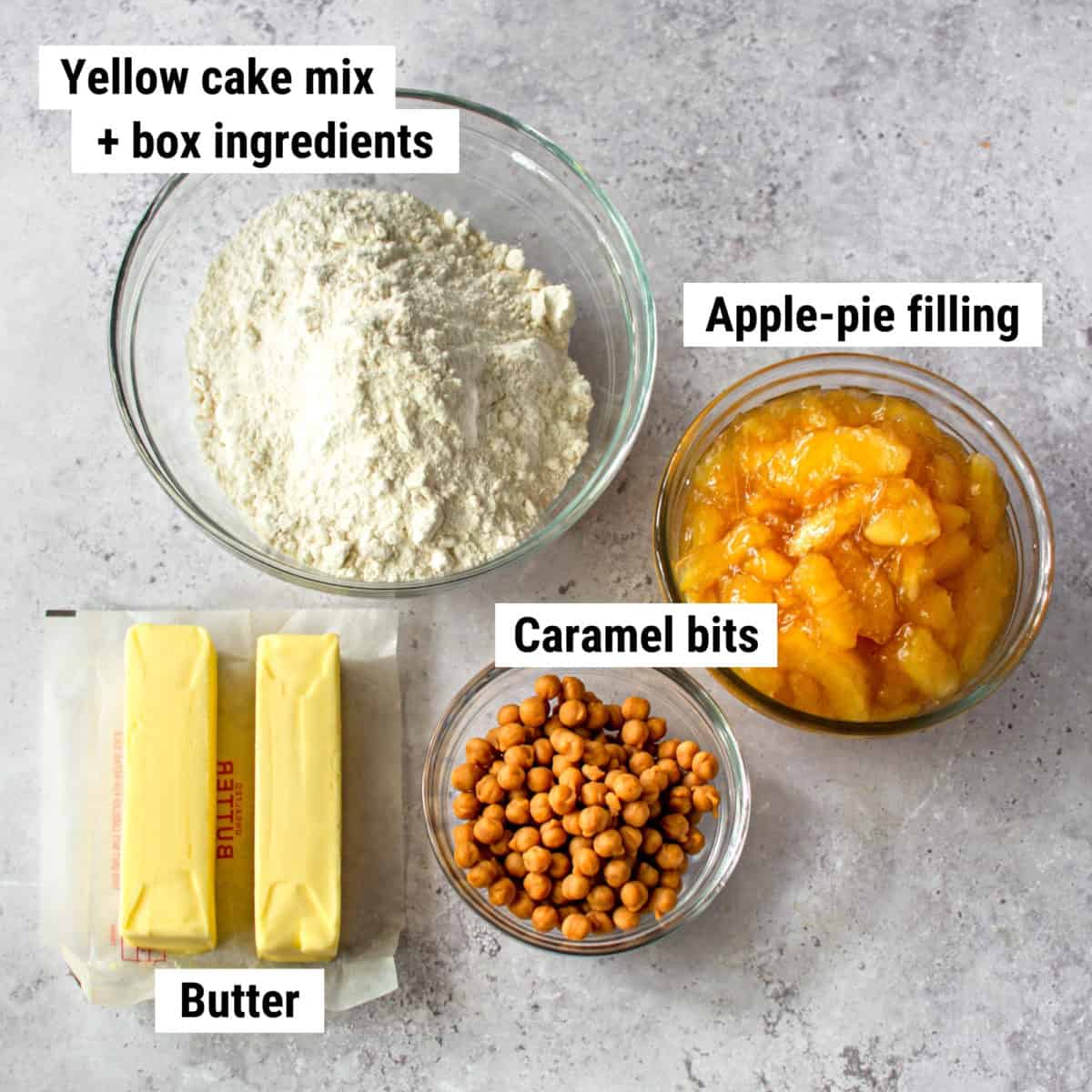 The ingredients to make apple caramel dump cake spread out on a table.