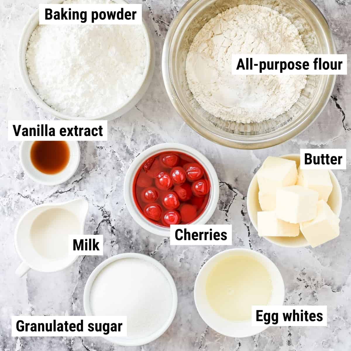The ingredients to make cherry cupcakes laid out on a table.