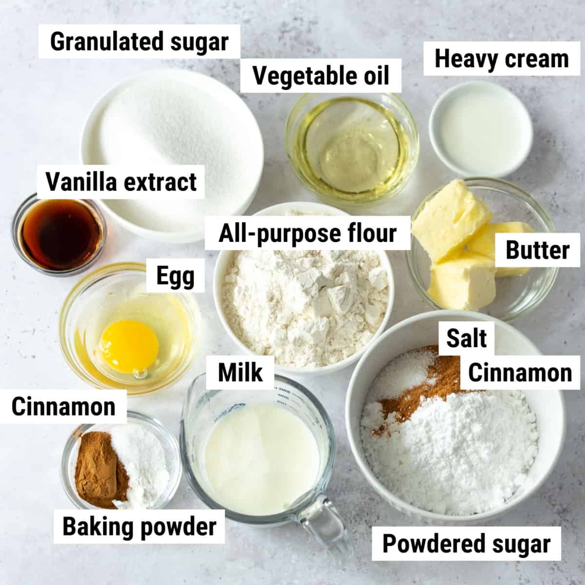 The ingredients used to make cinnamon cupcakes laid out on a table.