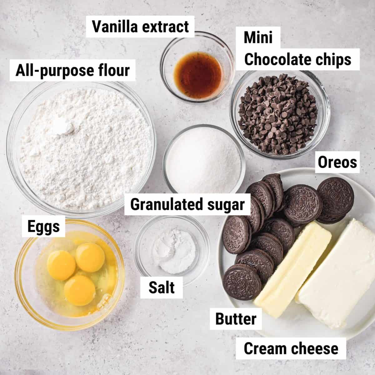 The recipe ingredients to make cookies and cream bars laid out on a table.