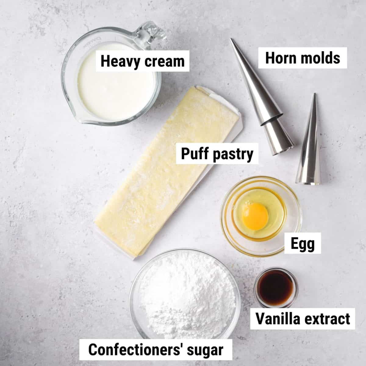 The ingredients used to make cream horns laid out on a table.