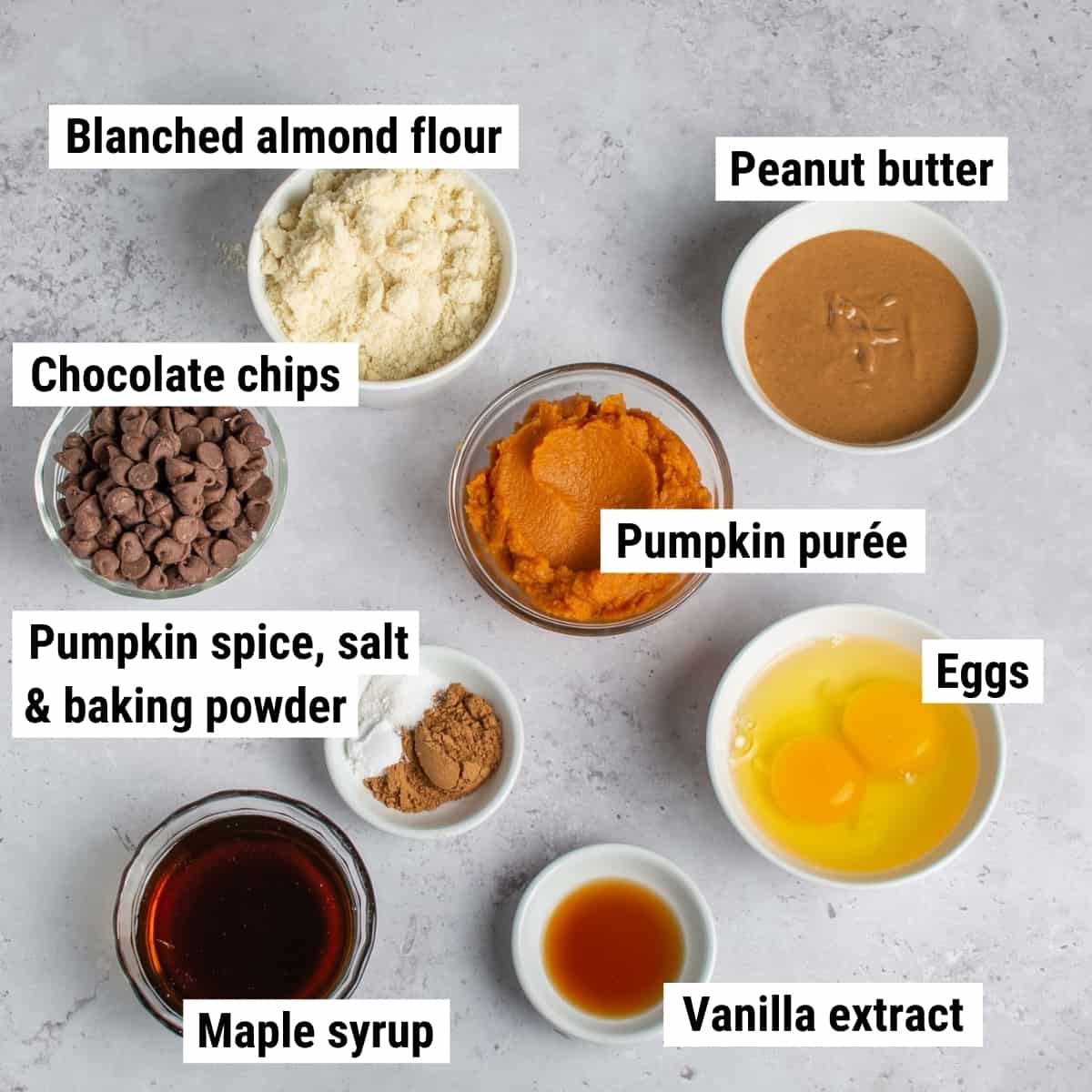 The ingredients used to make healthy pumpkin bars spread out on a table.