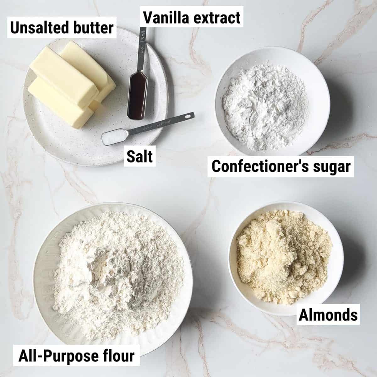 The ingredients used to make Italian wedding cookies spread out on a table.