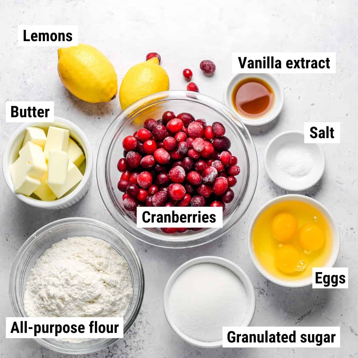The ingredients used to make lemon cranberry bars laid out on a table.
