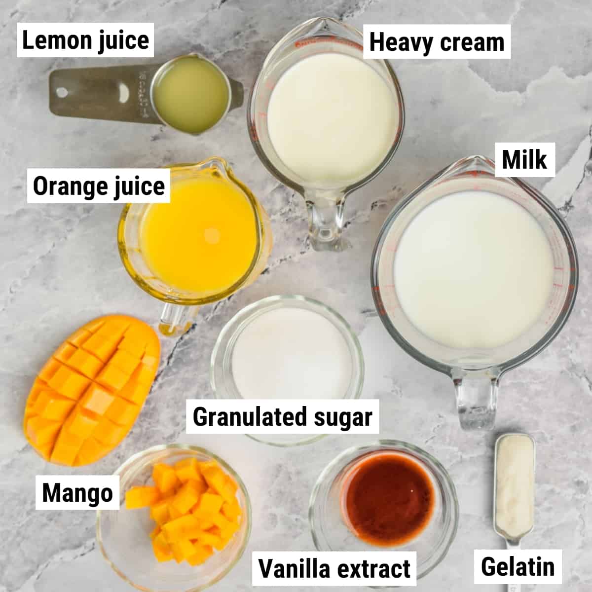 The ingredients to make mango panna cotta laid out on a table.