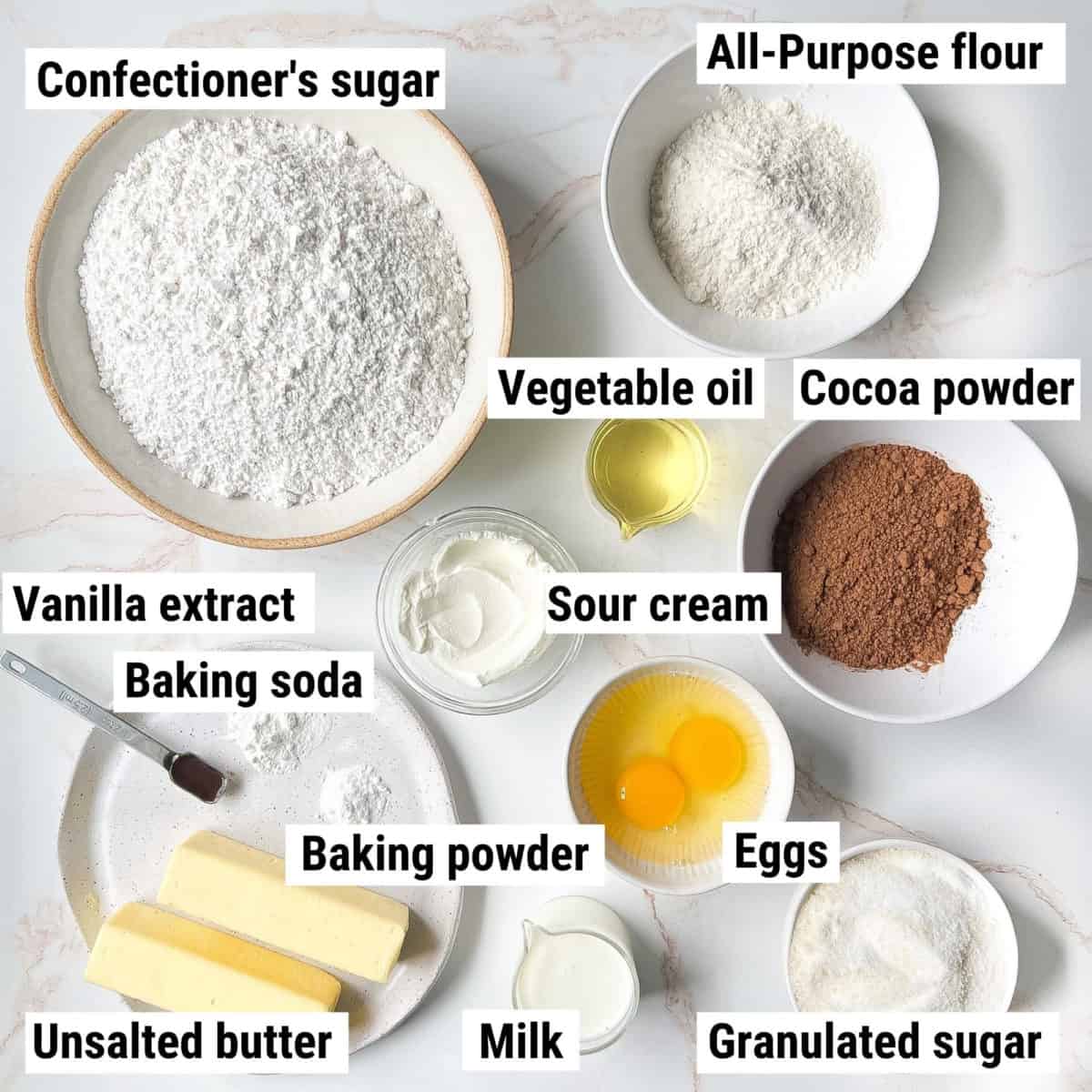 The ingredients used to make mini cupcakes spread out on a table.
