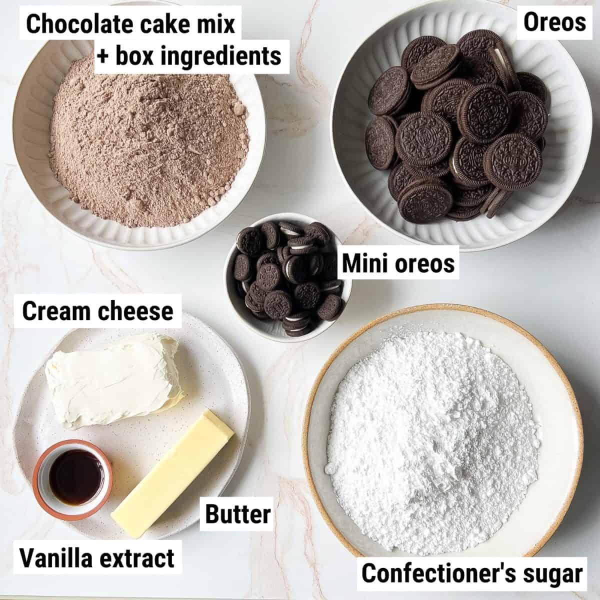 The ingredients used to make Oreo cupcakes spread out on a table.