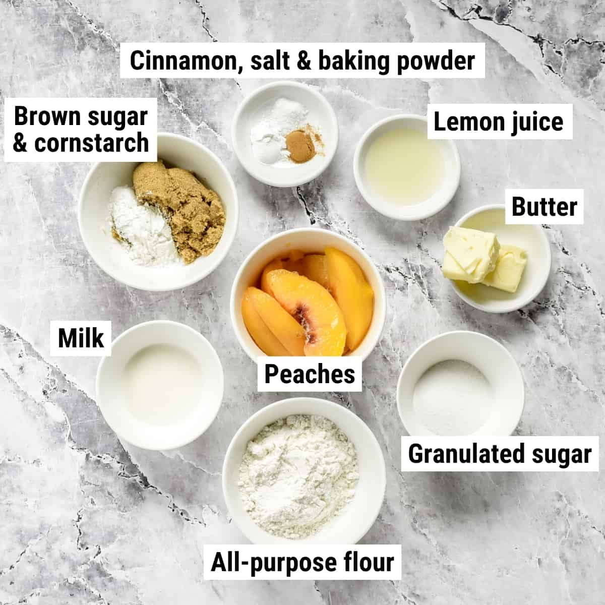 The ingredients to make peach cobbler laid out on a table.