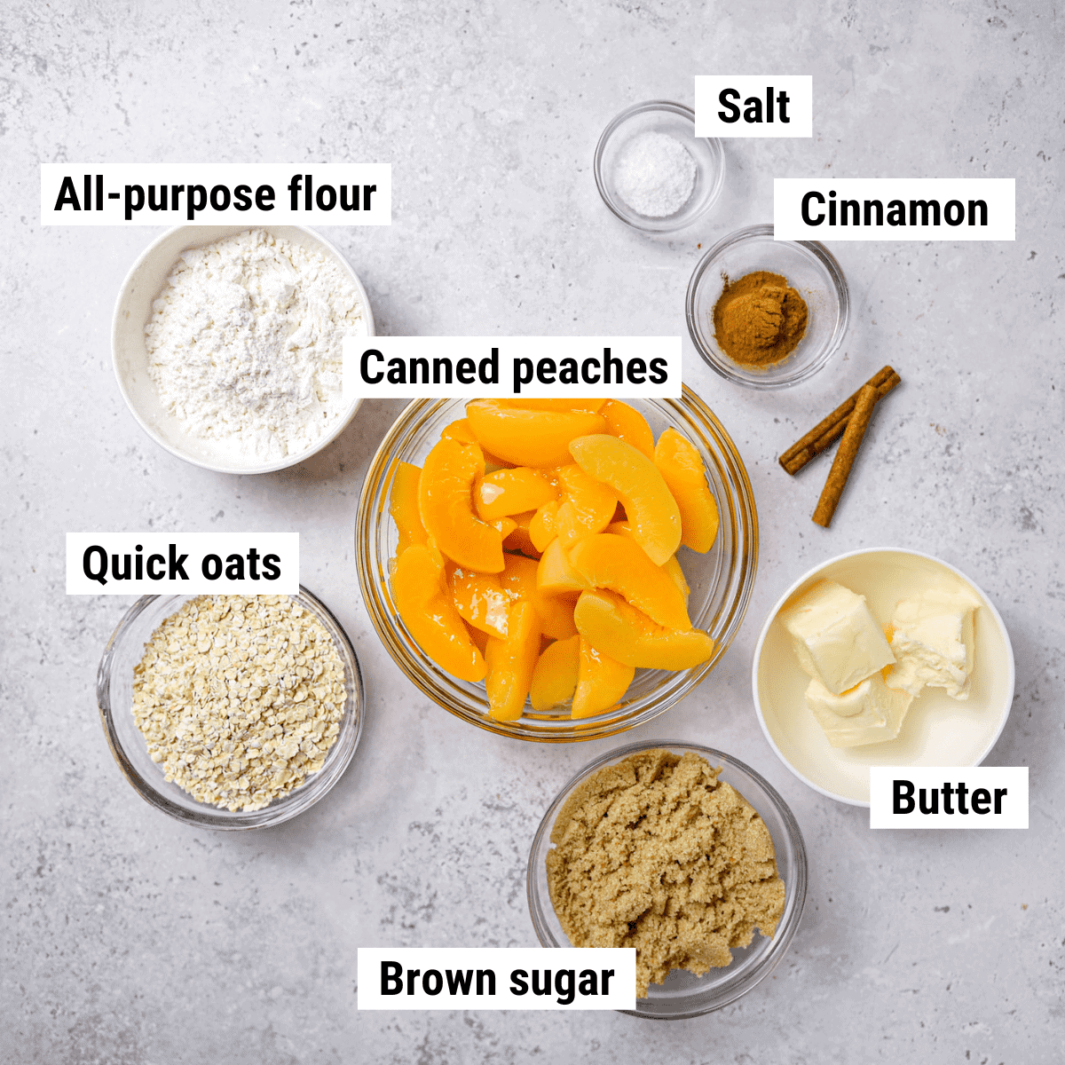 The ingredients to make peach crisp with canned peaches spread out on a table.