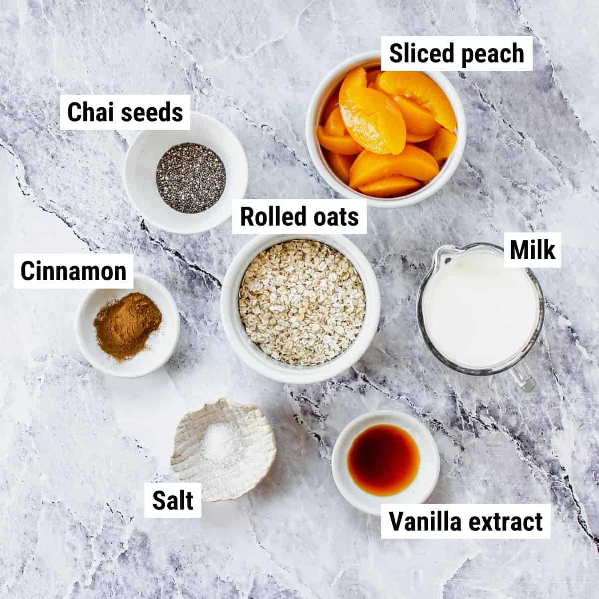 The ingredients to make peach overnight oats laid out on a table.