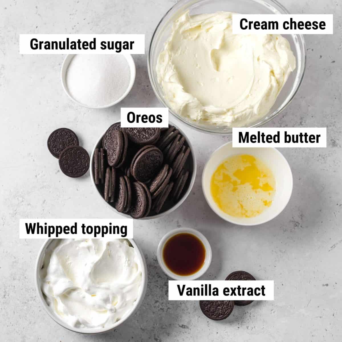 The ingredients used to make Philadelphia Oreo cheesecake spread out on a table.