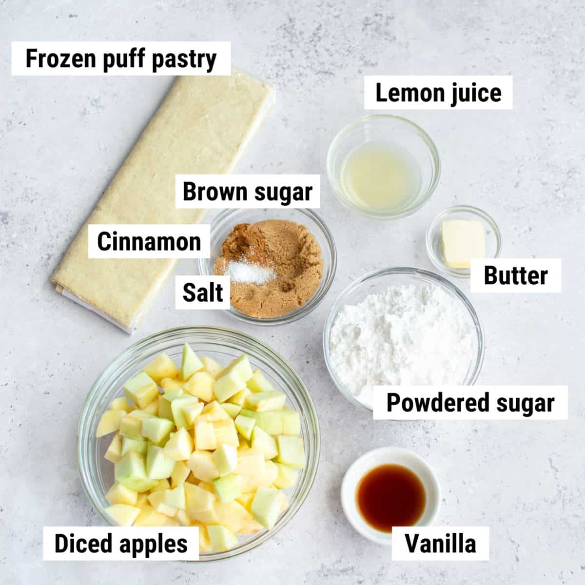 The ingredients used to make puff pastry apple turnovers laid out on a table.