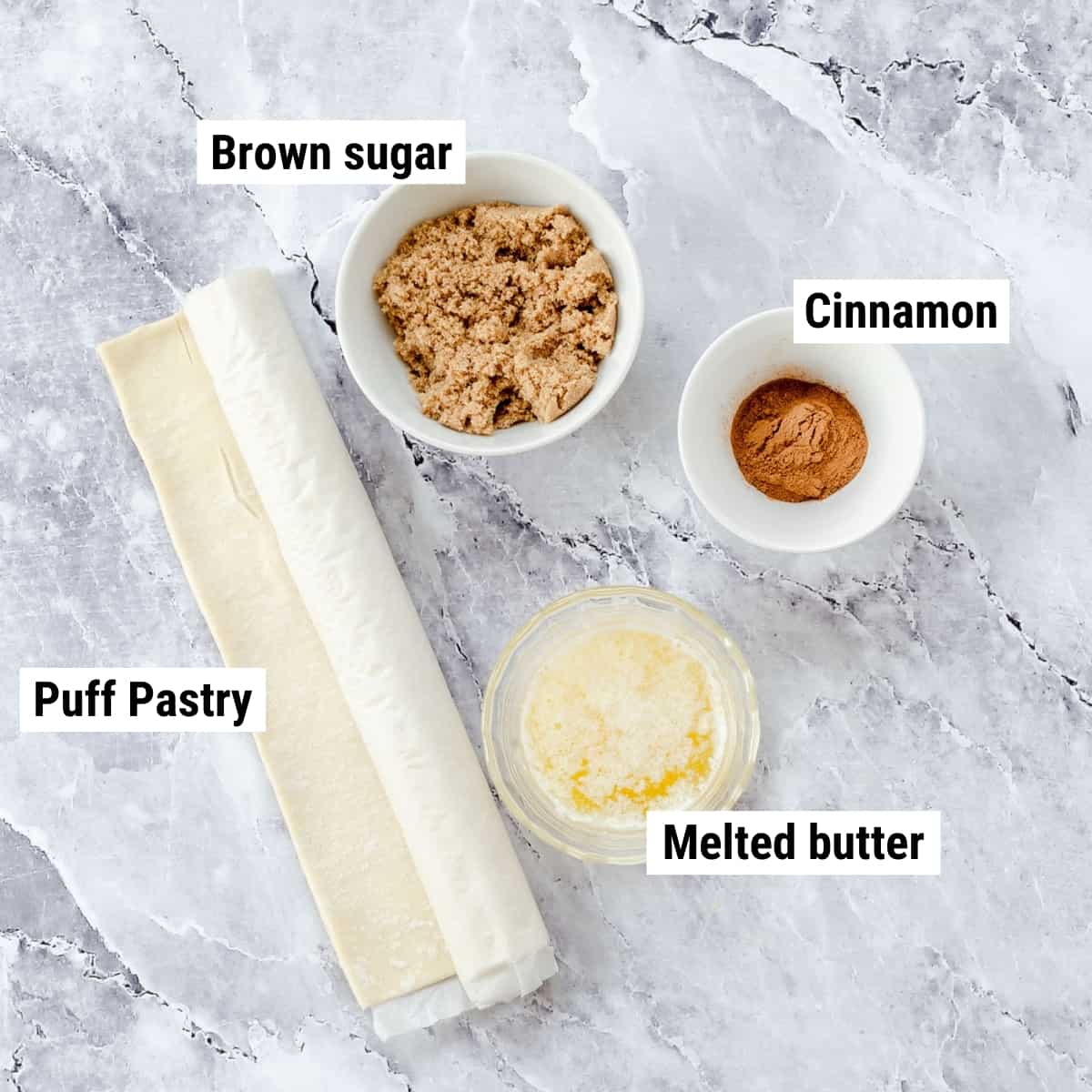 The ingredients to make puff pastry cinnamon twists laid out on a table.