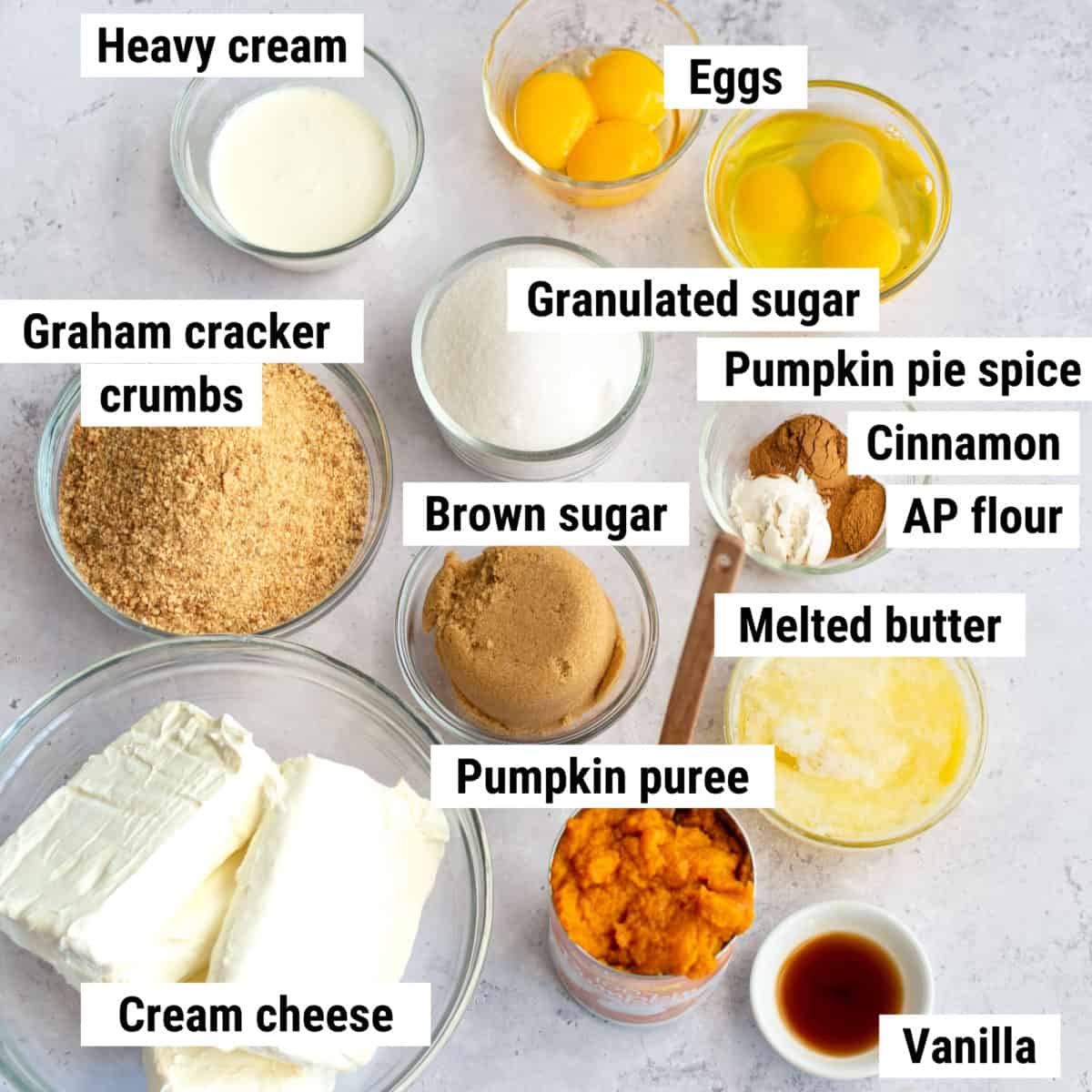 The ingredients to make pumpkin pie cheesecake bars laid out on a table.