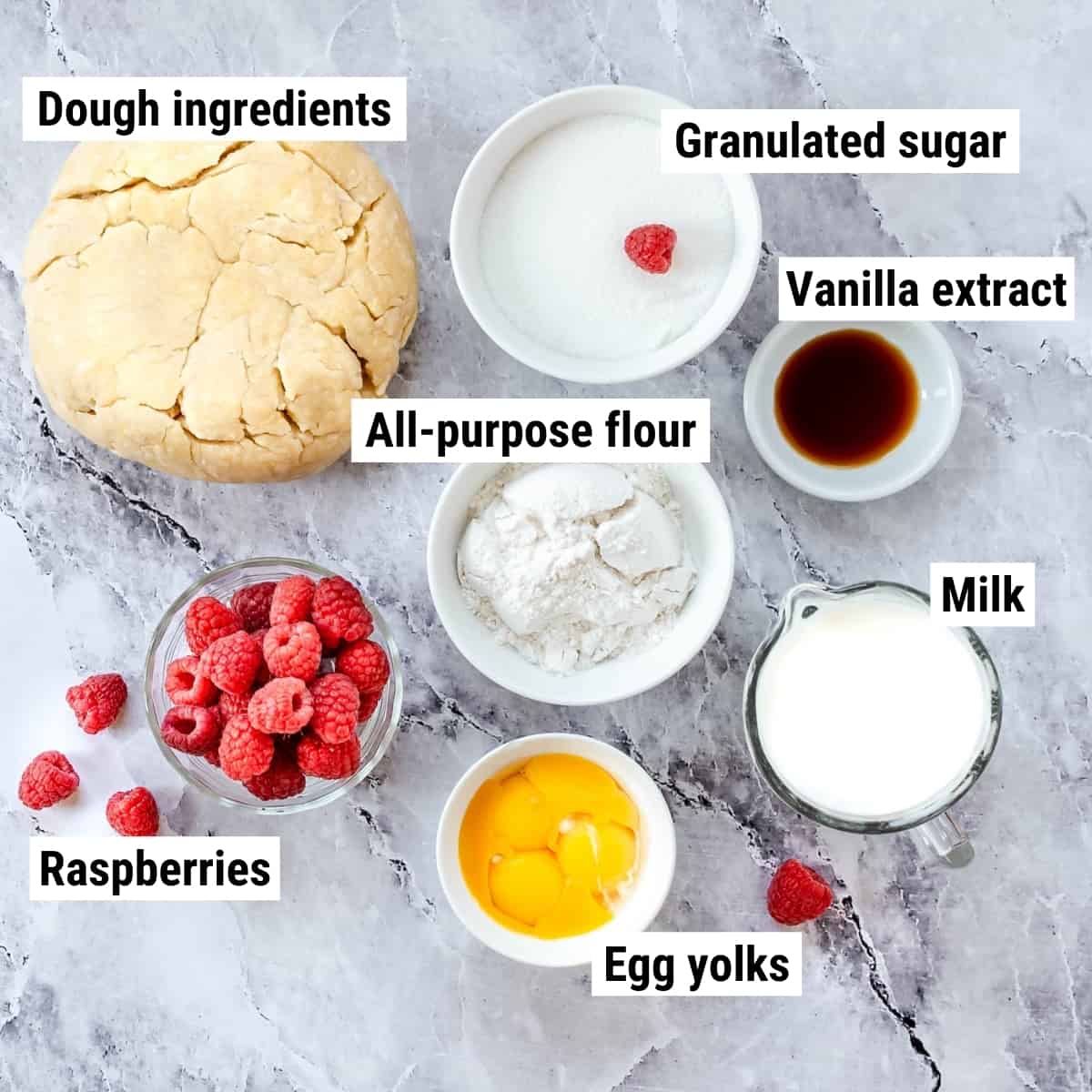 The ingredients to make raspberry custard tart laid out on a table.