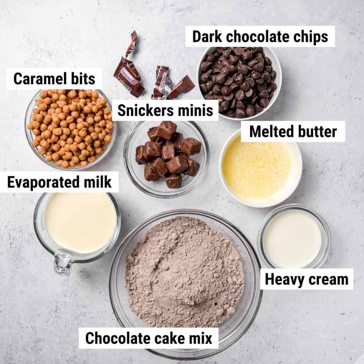 The ingredients used to make Snickers brownies laid out on a table.