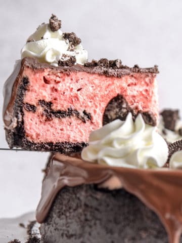 A slice of red velvet Oreo cheesecake being served.