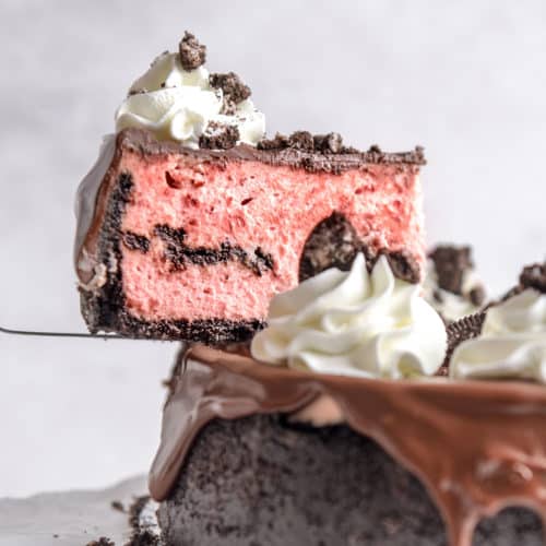 A slice of red velvet Oreo cheesecake being served.