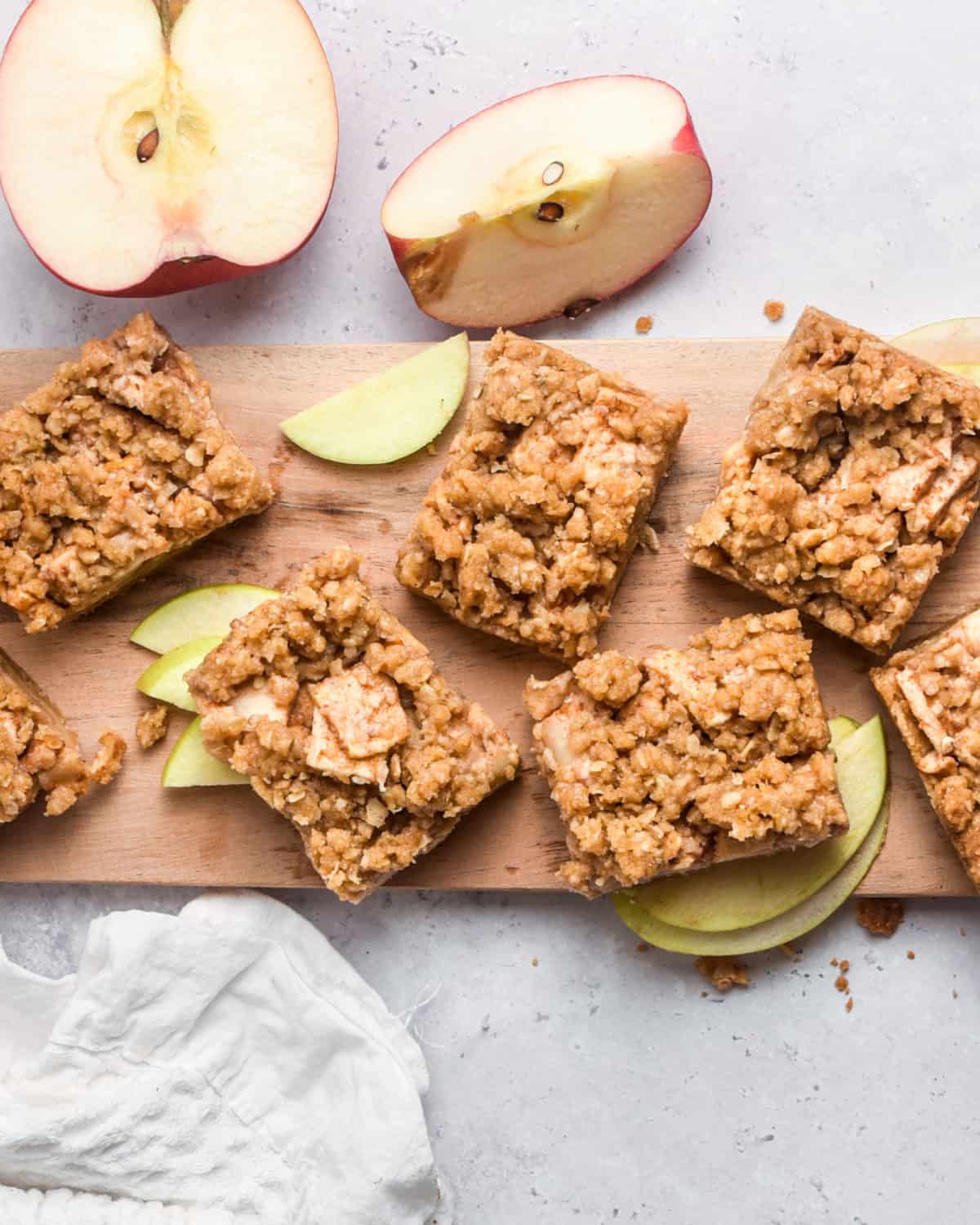 An overhead shot of several apple bars on a cutting board.