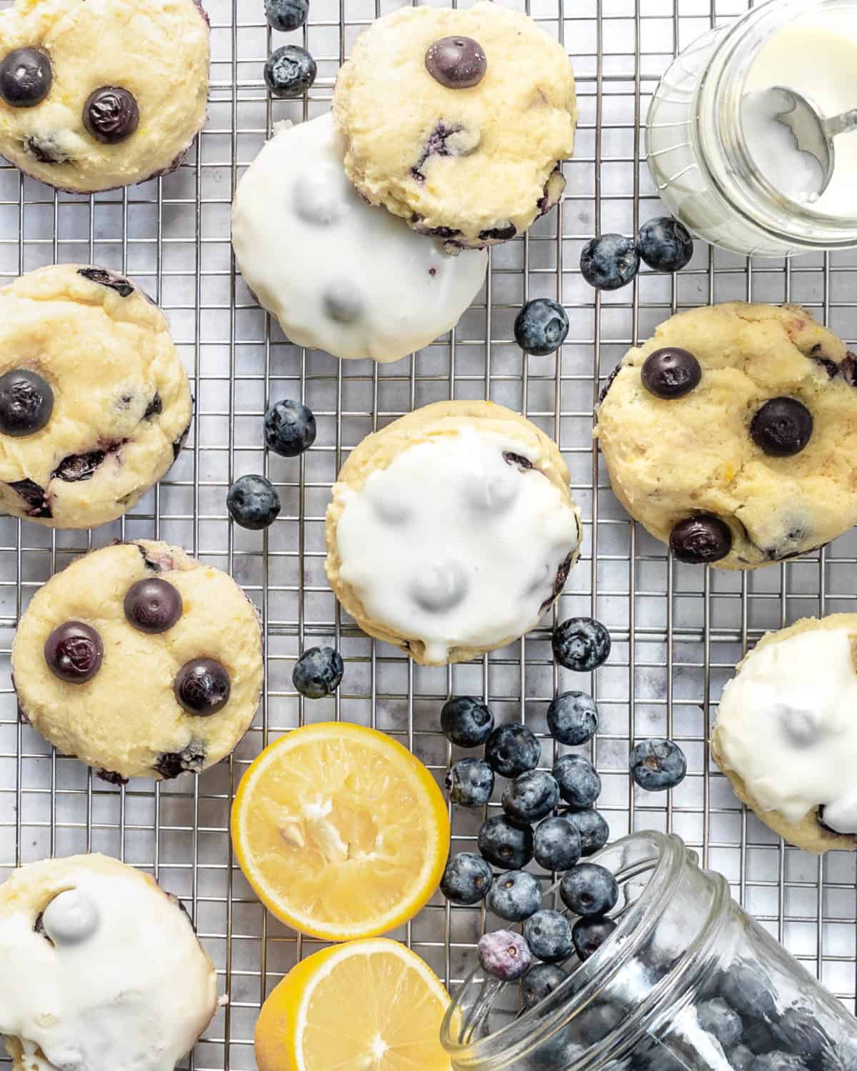 Several blueberry cookies with lemon on a cooling rack.