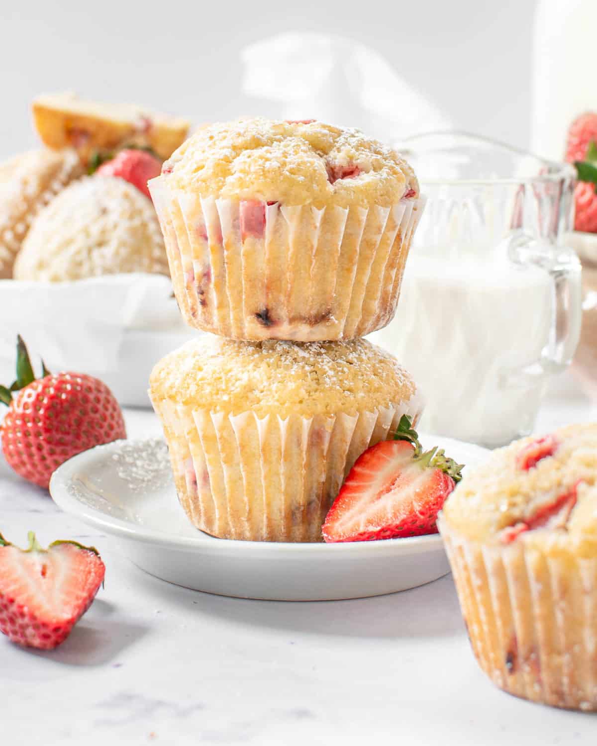 Two strawberry lemon muffins stack on each other.