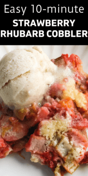 A bowl of strawberry rhubarb cobbler topped with a scoop of vanilla ice cream.