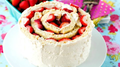 A strawberry shortcake roll up cake on a table.