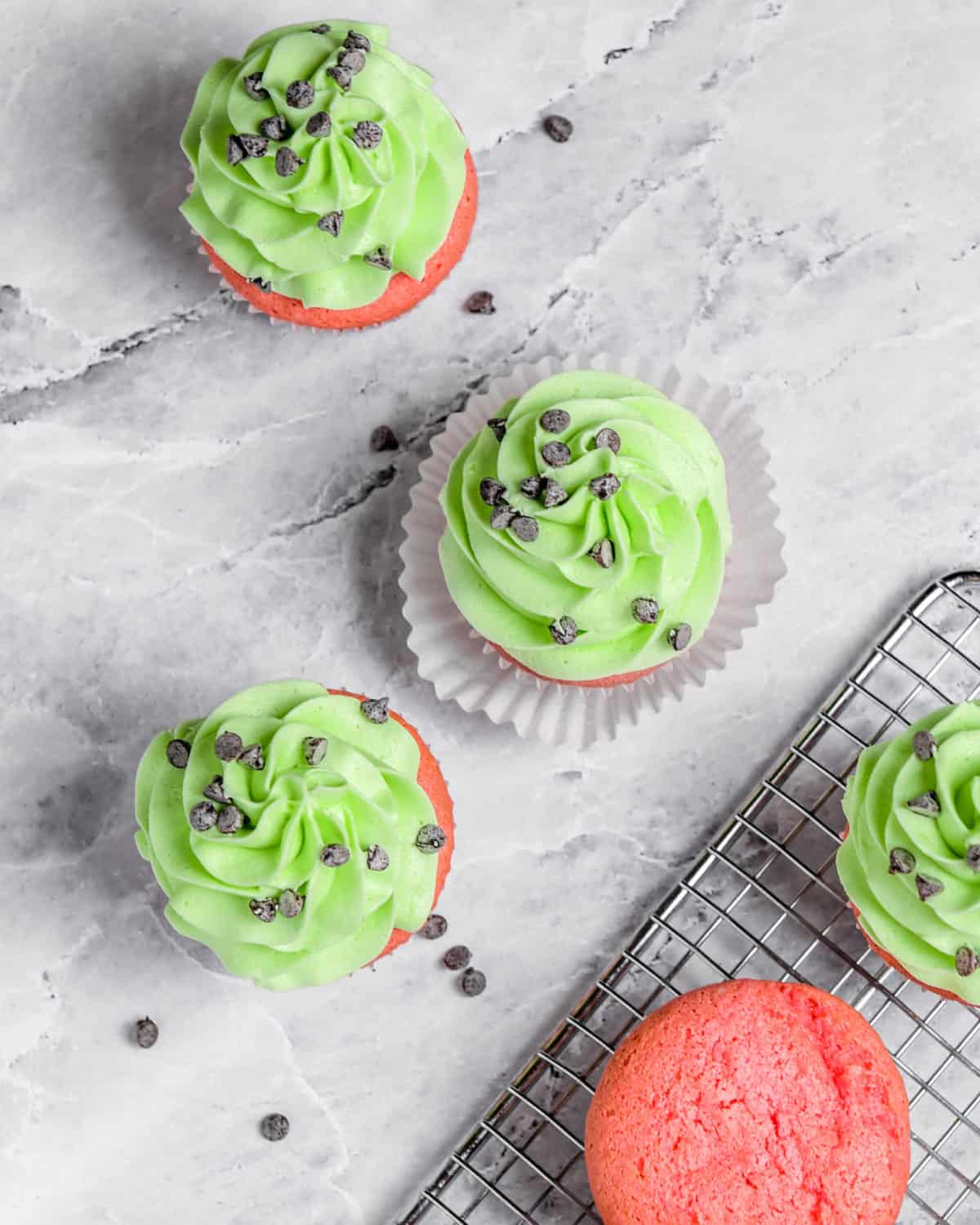 An overhead shot of several green and red watermelon cupcakes.