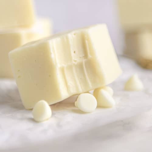 White chocolate fudge with a bite taken out of it.