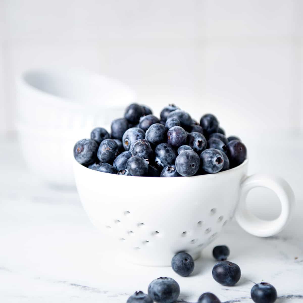 Blueberries in a white bowl.
