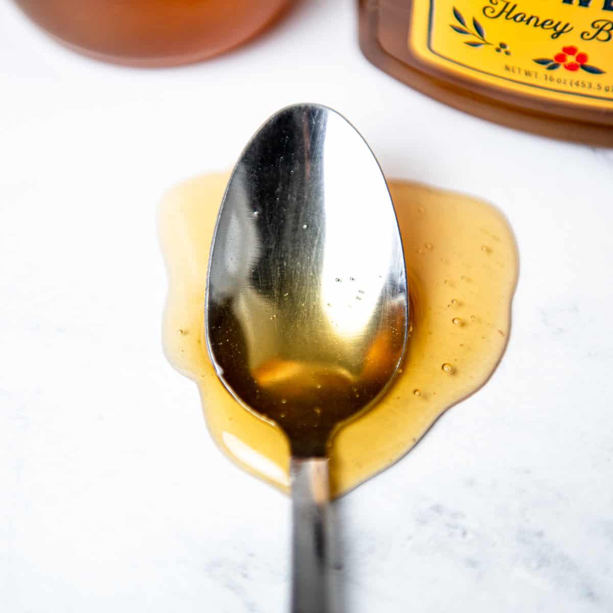Honey dripping off a spoon.