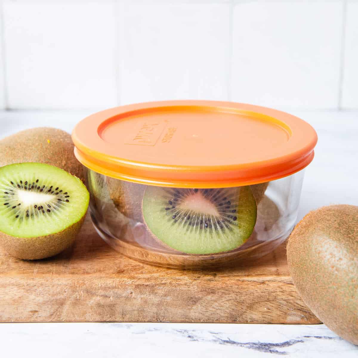 Kiwi cut and stored in glass container.