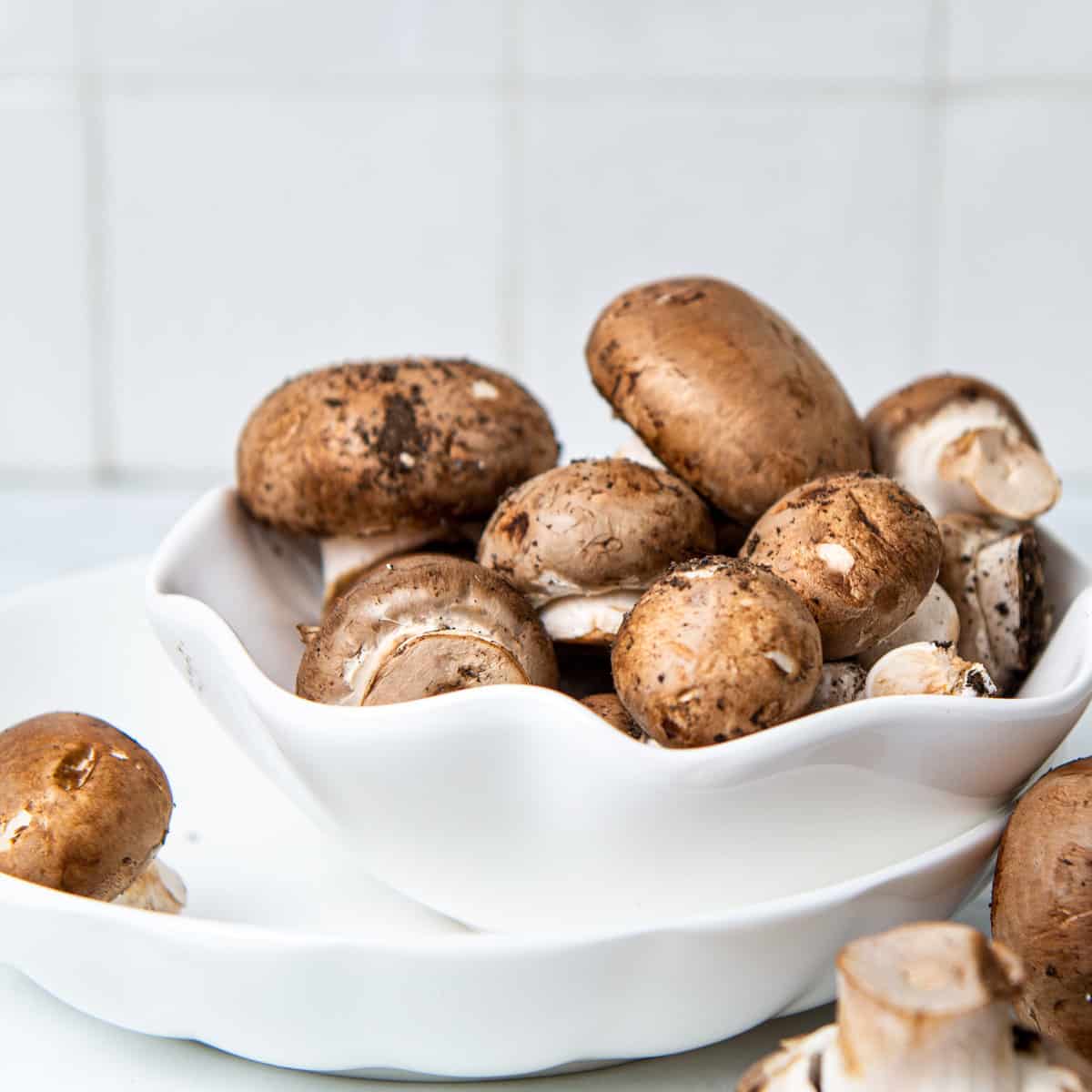 Mushrooms in a bowl on the counter.