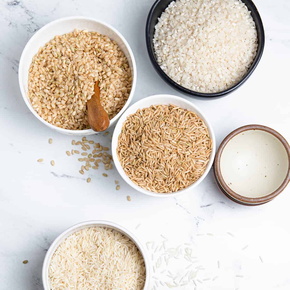 Rice in different bowls on a counter.