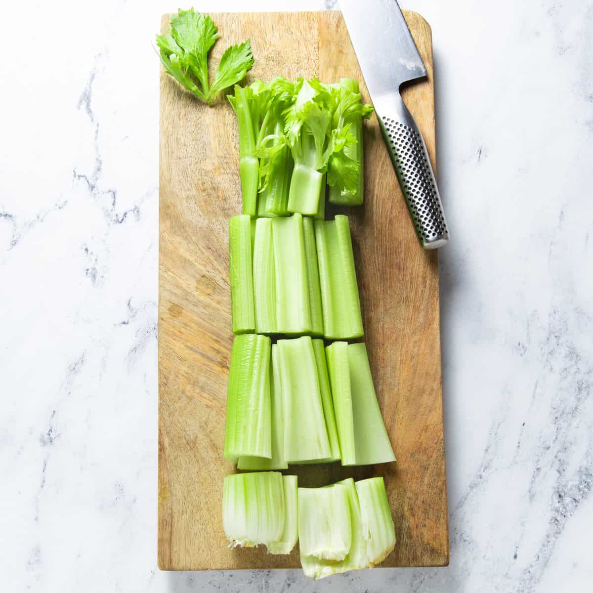 Sliced celery on a chopping board.
