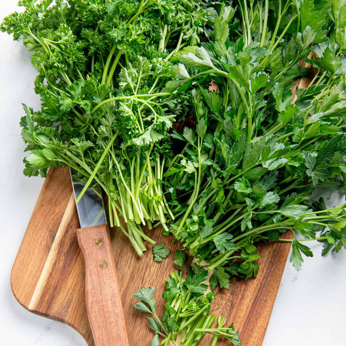 Trimmed parsley on a cutting board.